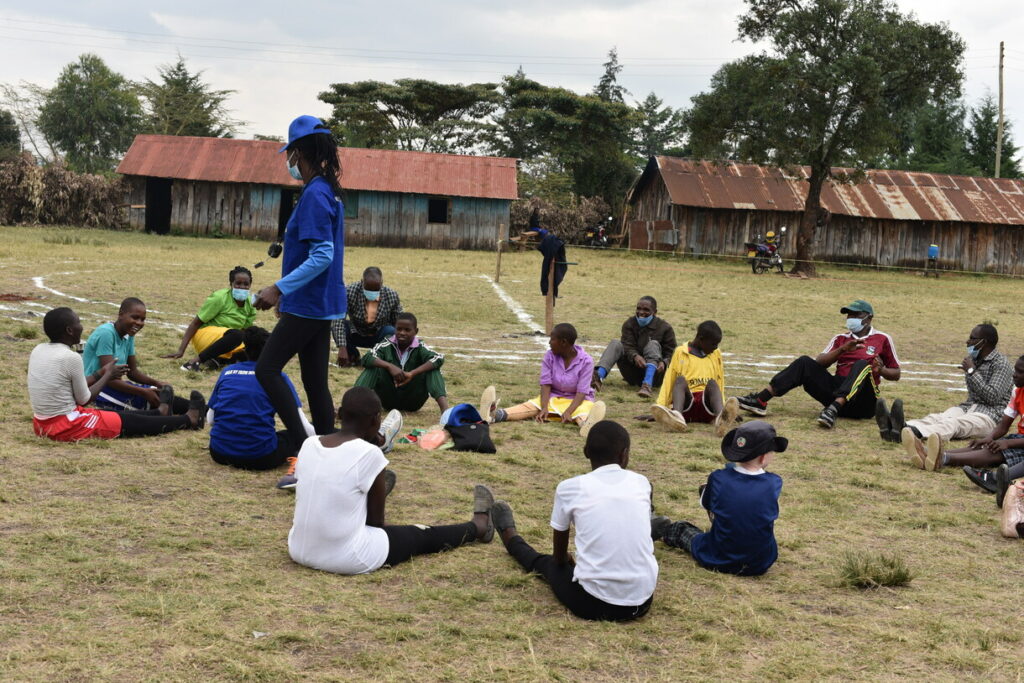 CPI kids gathered outside, sitting in a circle ready for activities.